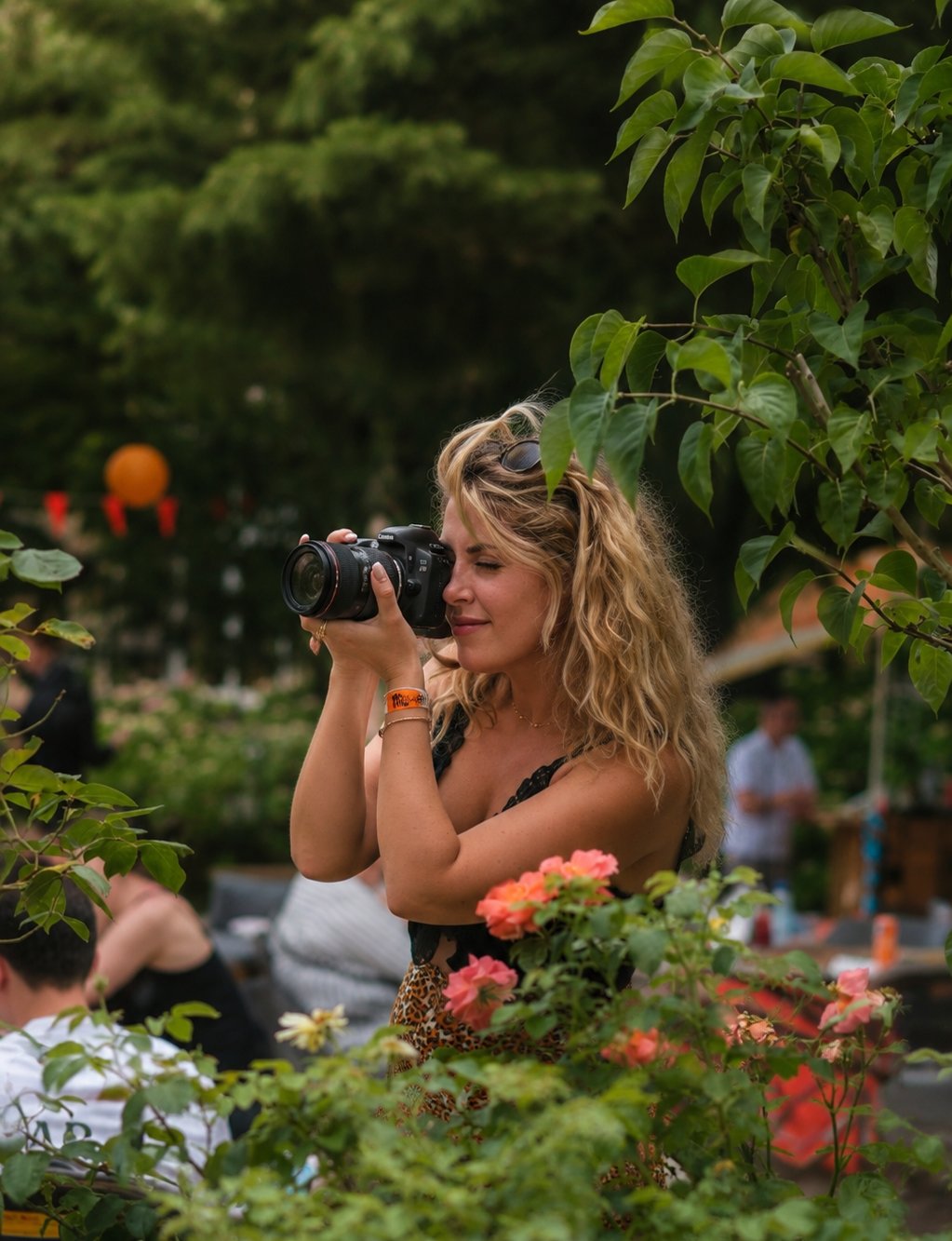 Katerina photographing with her camera in a garden