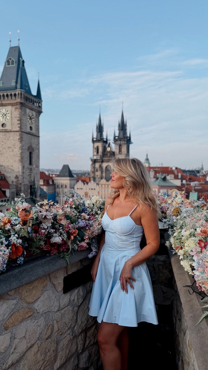 Katerina on a rooftop in Prague at golden hour